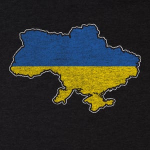 May include: A distressed graphic of the Ukrainian map in blue and yellow, the colours of the Ukrainian flag. The map is outlined in white against a black background. The design has a vintage, worn look.