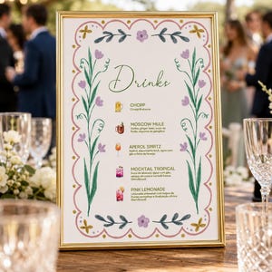 Pode incluir: Um menu de bebidas com moldura dourada, fundo branco, borda festonada rosa, vinhas verdes e flores roxas. O texto inclui Drinks, Chopp, Moscow Mule, Aperol Spritz, Mocktail Tropical e Pink Lemonade.