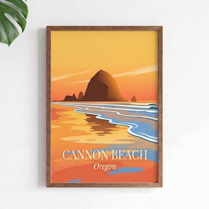 Könnte beinhalten: Ein gerahmter Kunstdruck mit einer stilisierten Illustration von Cannon Beach, Oregon, bei der Haystack Rock vor einem warmen orange-gelben Sonnenuntergangshimmel zentriert ist. Die Küste spiegelt die Farben wider und der Text lautet CANNON BEACH Oregon.