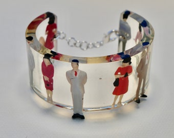 Standing in a queue resin cuff bangle.