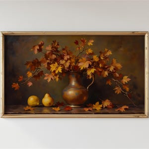 May include: A framed oil painting depicting a copper pitcher filled with autumn maple branches, accompanied by two yellow pears on a dark surface. The scene features scattered fallen leaves in shades of orange, red, and gold against a dark background.