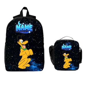 May include: A black backpack and a matching lunch bag, both featuring a space-themed background with stars and a nebula. Each item displays a cartoon yellow dog with a green collar and the word NAME in blue, stylized, bubble-style lettering.