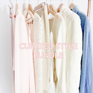 May include: A curated style bundle of clothing items hanging on a copper pipe rack. The bundle includes a white lace top, a white sweater, a white fur jacket, a light blue denim jacket, and a pink dress.