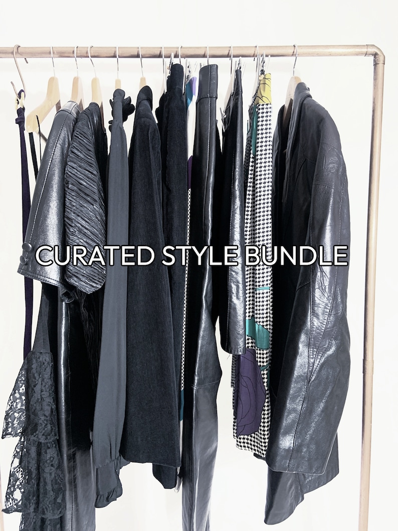 May include: A curated style bundle of clothing items hanging on a rack. The bundle includes a black lace dress, a black leather jacket, a black corduroy jacket, a black leather skirt, a black and white patterned skirt, and a black and green patterned dress. The text "CURATED STYLE BUNDLE" is printed on the rack.