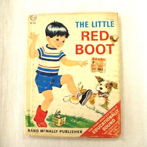 May include: Vintage children's book titled "The Little Red Boot." The cover features a boy in blue shorts and a striped shirt, wearing a red boot, with a dog. The book is published by Rand McNally.