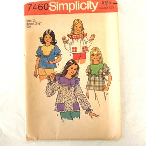 May include: Vintage Simplicity sewing pattern 7460 for girls' tops. The pattern features illustrations of four different top designs, with details including puff sleeves, ruffles, and various fabric patterns. The pattern is size 10, with a 28.5-inch bust.