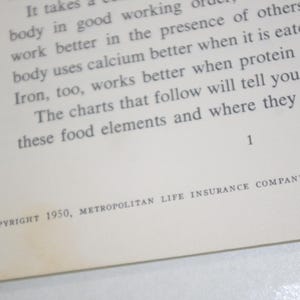 May include: Open book page with text about food elements and nutrition. The text includes the phrase "body uses calcium better" and "Iron, too, works better." The copyright reads "COPYRIGHT 1950, METROPOLITAN LIFE INSURANCE COMPANY."