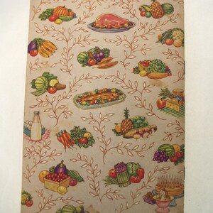 May include: Vintage cookbook cover with a beige background and a repeating pattern of food illustrations. The illustrations include fruits, vegetables, and cooked meats, with a decorative vine design. The text at the bottom reads "P.F.M. PRINTED IN U.S.A.--(a) 439 L.W. (Edition July 1950)".
