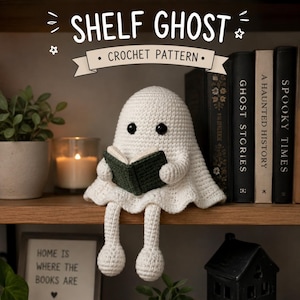 May include: A white crocheted ghost figure with black bead eyes, holding a small dark green book. The text above reads SHELF GHOST CROCHET PATTERN. The ghost has dangling legs and sits on a wooden shelf next to books and a candle.