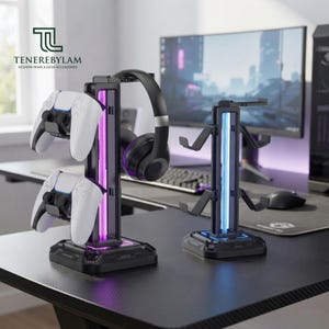May include: Two black gaming accessory stands with integrated LED lighting. The left stand holds two white game controllers and black headphones. The right stand features empty hooks for additional gear. Both have a sturdy base and vertical frame.