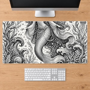 May include: A rectangular desk mat featuring a detailed black and white ink-style illustration of a mermaid surrounded by flowing seaweed, coral, seashells, and bubbles. The design includes intricate line work and pearl-like beaded accents.