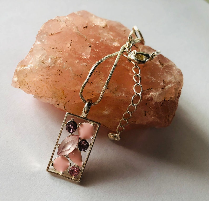 Necklace pendance,rectangle silver plated bezel with an eclectic mix of pink stones and a silver plated snake chain.