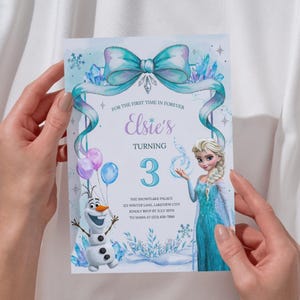 May include: A rectangular birthday invitation card featuring a light blue theme with a large teal bow at the top. It displays the text Elsie's Turning 3, an illustration of a blonde character in a blue dress, a snowman, balloons, and snowflakes.