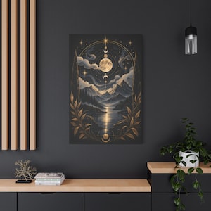 May include: A rectangular wall art print featuring a dark landscape with a full moon, mountain range, and a reflective lake. The scene is framed by golden botanical illustrations and celestial moon phases, set against a deep charcoal background.