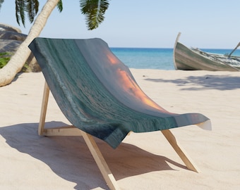 May include: A beach chair with a fabric seat featuring a scenic ocean view with waves and a sunset. The chair is made of light-colored wood and is positioned on a sandy beach. A palm tree and a boat are visible in the background.
