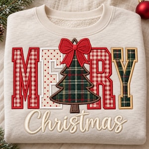 May include: A cream-colored sweatshirt featuring the embroidered text MERRY CHRISTMAS. The letters M, R, and Y are filled with red and white gingham and green plaid patterns. A green plaid Christmas tree with a red bow replaces the letter E.