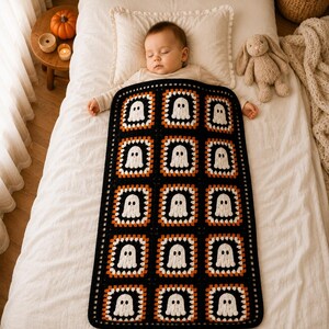May include: A rectangular crochet blanket featuring a repeating pattern of white ghost motifs centered within orange and black square frames. The blanket is constructed from individual granny squares joined together with a black border.