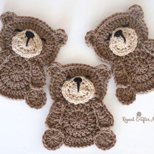 Puede incluir: Tres osos de peluche de ganchillo hechos a mano en tonos marrones y beige. Cada oso tiene un cuerpo redondo, una cara de color más claro y detalles negros para los ojos y la nariz. Los osos están dispuestos sobre una superficie blanca.
