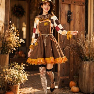 May include: A brown scarecrow costume featuring a pointed hat with a sunflower, a long-sleeved shirt with a brown, white, and orange checkered pattern, a brown overall dress with orange fringe trim, and black fishnet stockings with black heels.