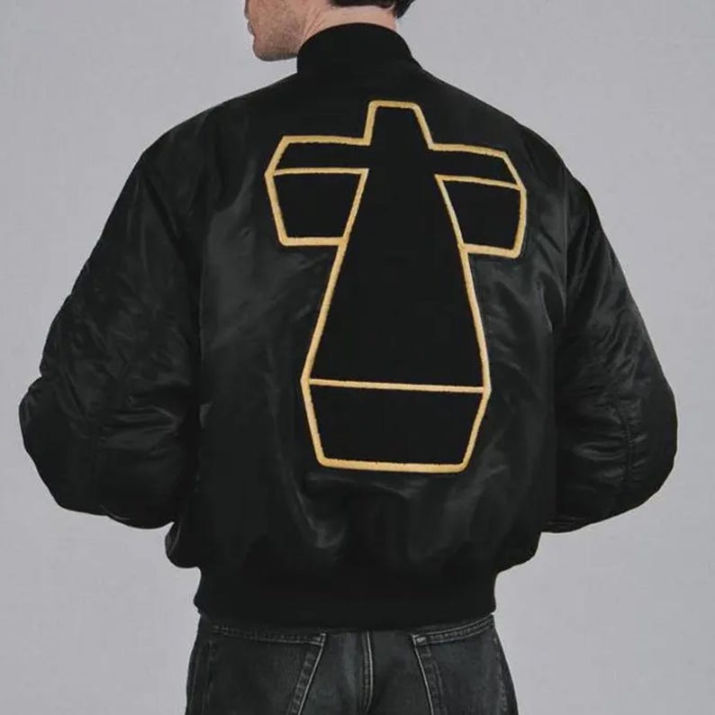 Justice Cross satin varsity jacket shown from the front, featuring a vintage-inspired unisex bomber silhouette with embroidered cross detailing. The smooth satin finish gives this streetwear jacket a bold retro appearance, while the classic varsity design makes it easy to style with jeans, sneakers, casual trousers, or layered outfits.