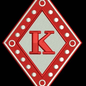 May include: Red diamond-shaped patch with a white border and white dots around the edge. The centre of the patch is white with a red letter "K" in the centre.