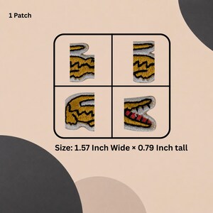 May include: An embroidered patch featuring a yellow crocodile design divided into four separate segments within a rounded square frame. The patch measures 4 cm wide by 2 cm tall. The design includes black outlines and a red mouth.