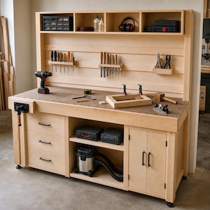 May include: A light-colored wooden workbench featuring a backboard with tool storage racks, a top shelf with organizers, and a work surface with a vise. The base includes three drawers, an open shelf with a shop vacuum, and a two-door cabinet.