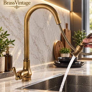 May include: A high-arc kitchen faucet with a brushed antique brass finish, featuring a pull-down spray head with a flexible coiled hose. The faucet includes a single side-mounted lever handle and is dispensing a steady stream of water into a sink.