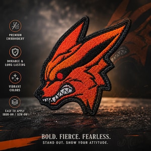 May include: An embroidered patch featuring a stylized orange and black fox head with sharp teeth and red eyes. Text on the left reads: PREMIUM EMBROIDERY, DURABLE & LONG LASTING, VIBRANT COLORS, EASY TO APPLY IRON-ON / SEW-ON. Bottom text: BOLD. FIERCE. FEARLESS. STAND OUT. SHOW YOUR ATTITUDE.