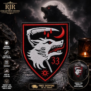 May include: A shield-shaped embroidered patch featuring a white wolf head in profile with a red tongue, a scythe above, three red blood drops, a red crescent moon, the number 33 in red, and a red star at the bottom, all on a black background.