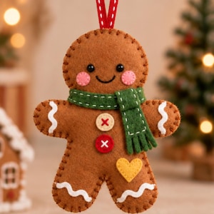 May include: A brown felt gingerbread person ornament featuring a green scarf, two buttons with white cross-stitching, a yellow heart patch, pink cheeks, and white wavy icing details on the arms and legs, suspended by a red and white ribbon.