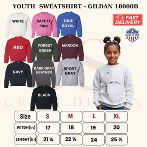 May include: A Gildan 18000B youth sweatshirt color chart displaying white, safety pink, true royal, red, forest green, maroon, navy, dark gray heather, sport gray, and black options, with a size chart in inches for small, medium, large, and extra-large.