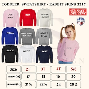 May include: A collection of Rabbit Skins 3317 toddler sweatshirts in light pink, red, natural heather, royal blue, dark gray heather, sport gray, black, white, and navy. Includes a size chart with width and length measurements in inches.