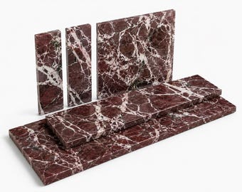 May include: A collection of five rectangular marble tiles featuring a deep burgundy red base color with prominent, intricate white veining throughout. The set includes three upright vertical tiles of varying widths and two horizontal tiles.
