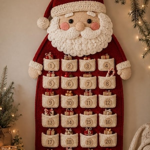 May include: A wall-hanging Santa Claus advent calendar made of red and white crochet. The design features a Santa face at the top and twenty-four cream-colored pockets, each labeled with a wooden number disc from 1 to 24, containing small gift boxes.