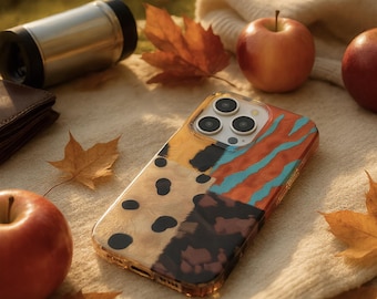 May include: A smartphone case featuring a multi-patterned design with sections of tan with black spots, dark brown patches, and orange with teal wavy stripes. The case has a clear camera cutout showing three lenses and a flash on the back of the device.