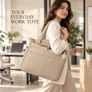 May include: A beige quilted tote bag featuring vertical stitching, a large main compartment, and exterior pockets. The bag contains a notebook, a smartphone, and a water bottle. The text "YOUR EVERYDAY WORK TOTE" is printed on the upper left side.