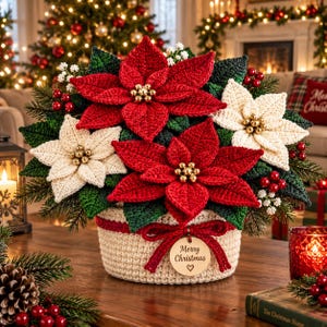 May include: A crochet poinsettia arrangement featuring vibrant red and cream-colored flowers with gold bead centers, green leaves, and red berries. The flowers are housed in a cream-colored crochet basket with a red bow and a wooden tag reading Merry Christmas.