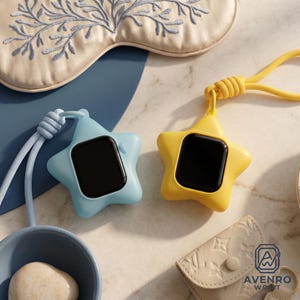 May include: Two star-shaped silicone cases for smartwatches, one in light blue and one in yellow, each featuring a matching cord lanyard. The cases hold black smartwatch screens. A beige embroidered eye mask and a small beige pouch are visible.