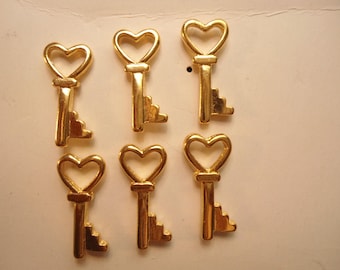 6 broches chapados en oro con la llave de mi corazón
