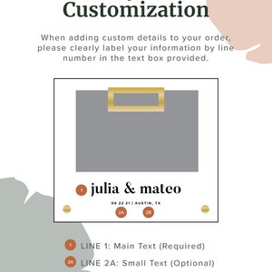 May include: A gray rectangular box with a gold border and a gold rectangle inside. The text "julia & mateo" is below the box, along with the date "06 22 21" and the location "AUSTIN, TX".  The text "LINE 1: Main Text (Required)" is below the box, along with the text "LINE 2A: Small Text (Optional)" and "LINE 2B: Small Text (Optional)".