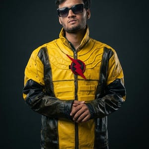 May include: A yellow and black leather jacket featuring a high collar, a front zipper closure, and a prominent red lightning bolt emblem on the chest. The jacket has textured paneling across the shoulders and chest with black sleeves and accents.