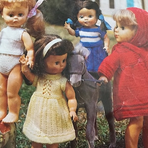 May include: Four dolls wearing knitted clothing. One doll is riding a toy horse. The dolls are wearing a white, blue and white striped, yellow, and red knitted outfits.