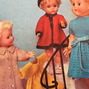May include: Three knitted doll outfits, one in pink, one in blue, and one in red. The dolls are not included in the image.