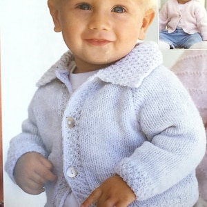 May include: A light blue knitted cardigan with a button closure and a white collar. The cardigan has a textured knit pattern and is suitable for a baby or toddler.