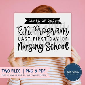 May include: A white rectangular sign with black text that reads CLASS OF 2026, R.N. Program, LAST FIRST DAY OF, and Nursing School. The sign features a black banner graphic at the top and is held up against a solid pink background.