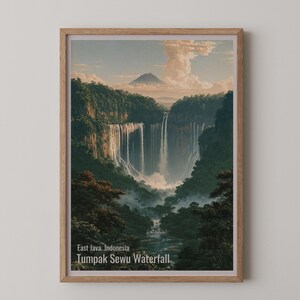 May include: A framed wall art print depicting the Tumpak Sewu Waterfall in East Java, Indonesia. The image features a large, multi-tiered waterfall cascading down a lush, green cliffside with a distant mountain peak and a cloudy sky above.