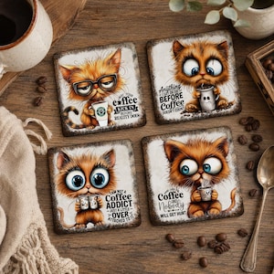 May include: A set of four square coasters featuring illustrations of orange cats with large blue eyes holding coffee mugs. Each coaster includes text: "May your coffee kick in before reality does," "Anything I say or do before coffee doesn't count," "I am not a coffee addict, just a little over attached to it," and "Hand over the coffee and nobody will get hurt."