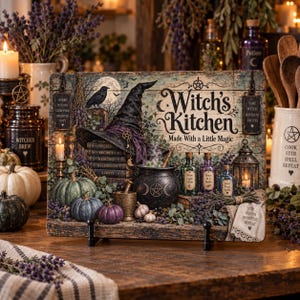 May include: A rectangular wooden sign featuring the text Witch's Kitchen Made With a Little Magic. The design includes a black witch hat, a stack of books, a cauldron, glass bottles, pumpkins, and lavender sprigs on a rustic wood background.