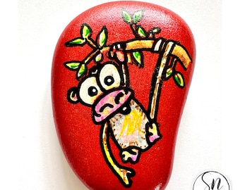 Unique Gift - Hand-painted stone with monkey hanging on a branch on metallic red background